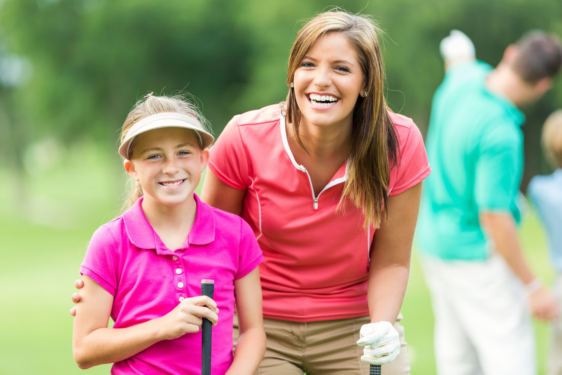 Mother have fun with daughter while playing golf together.